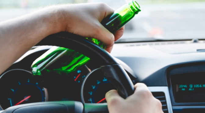 bottle in hand while driving