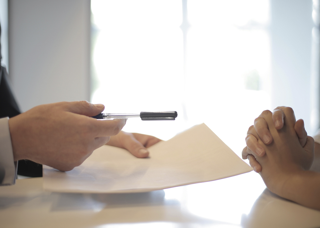 hands with documents and pen